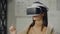 Portrait woman architect designer in virtual reality helmet with hands imitates work of interface. Designing the future