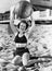 Portrait of woman with ball at beach