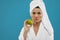Portrait of woman in bathrobe holding apple.