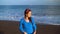 Portrait of a woman in a beautiful blue dress on a black volcanic beach. Filmed at different speeds - accelerated and