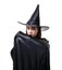 Portrait of woman in black Scary witch halloween costume standing with hat isolated on white background