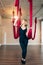 Portrait of woman in black sportive suit during anti-gravity aerial yoga class