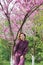 Portrait of a woman in blooming trees. Spring inspiration. Blossom. Positive emotions. Female. International Woman& x27;s day.