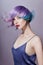 Portrait of a woman with bright colored flying hair, all shades of purple. Hair coloring, beautiful lips and makeup. Hair