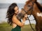 Portrait of woman and brown horse. Asian woman hugging horse. Romantic concept. Human animals relationship. Nature concept. Bali