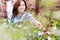 Portrait of woman buyer pointing flower in shop