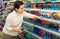 Portrait of woman choosing ball pen at stationery store