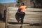 Portrait of woman climbing wooden wall during obstacle course