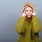 Portrait of woman concentrating against gray background