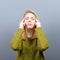 Portrait of woman concentrating against gray background