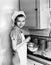 Portrait of woman cooking with flour on face