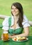 Portrait of woman in dirndl with beer and food