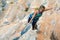 Portrait of Woman doing Exercise on vertical rocky Wall