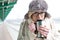 Portrait of woman drinking coffee from insulated drink container during winter