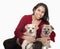 Portrait of woman embracing her dogs, studio shot