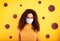 Portrait of woman with face mask against covid-19. yellow background