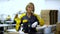 Portrait of woman factory worker standing near the production packaging line at plant for production of electrical