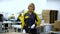 Portrait of woman factory worker standing near the production packaging line at plant for production of electrical