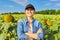 Portrait of woman farmer, agronomist in field with ripe sunflower