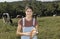 Portrait of a woman farmer with some cows