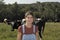 Portrait of a woman farmer with some cows