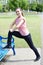 Portrait Of Woman In Fitness Clothing Doing Stretches Using Park