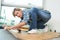 Portrait woman fitting laminated floor boards