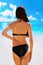Portrait of woman flaunting her bottom in bikini.Sun Cream. Skin and Body Care. Sunscreen to Her Skin.