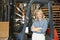 Portrait Of Woman With Fork Lift Truck In Warehouse