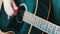 Portrait of woman with guitar, closeup of young woman`s hand