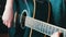 Portrait of woman with guitar, closeup of young woman`s hand