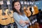 Portrait woman in guitar shop