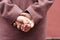 Portrait of a woman hands in a burgundy coat view from the back