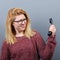 Portrait of woman having unpleasant phone calll against gray background