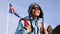 Portrait of woman with Iceland flag waving in wind