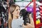 Portrait Of Woman Kissing French Bulldog At Store