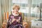 Portrait of woman knitting a vintage wool quilt