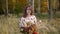 Portrait of woman looking at bouquet of wild flowers in summer.