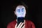 Portrait of a woman looking at her mobile phone like a zombie. Black background. Copy space. The concept of online addiction