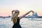 Portrait of a woman looking at the Santa Maria della Salute church in Venice. Girl wearing a black mask admiring the