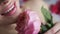 Portrait of a woman lying in the bathroom with foam and holding a pink rose