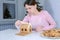 Portrait of woman making gingerbread house glues details sugar sweet icing.