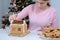 Portrait of woman making gingerbread house glues details sugar sweet icing.