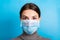 Portrait of a woman in medical mask with SARS virus text at blue background. concept. Respiratory protection