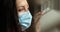 Portrait woman in medical protective mask, self-isolation at home. Lockdown, quarantine during pandemic. Sad Caucasian