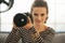 Portrait of woman with modern dslr photo camera