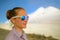 Portrait of a woman in mountain sunglasses. Tourist climber on the background of Mount Kazbek