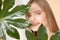 Portrait woman with natural green leaf, blond model girl with clear skin face. Concept Fashion flora beauty