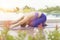 Portrait of woman playing yoga beside swimming pool