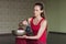 Portrait of a woman practicing yoga, performs sound meditation using a metal bowl in the studio